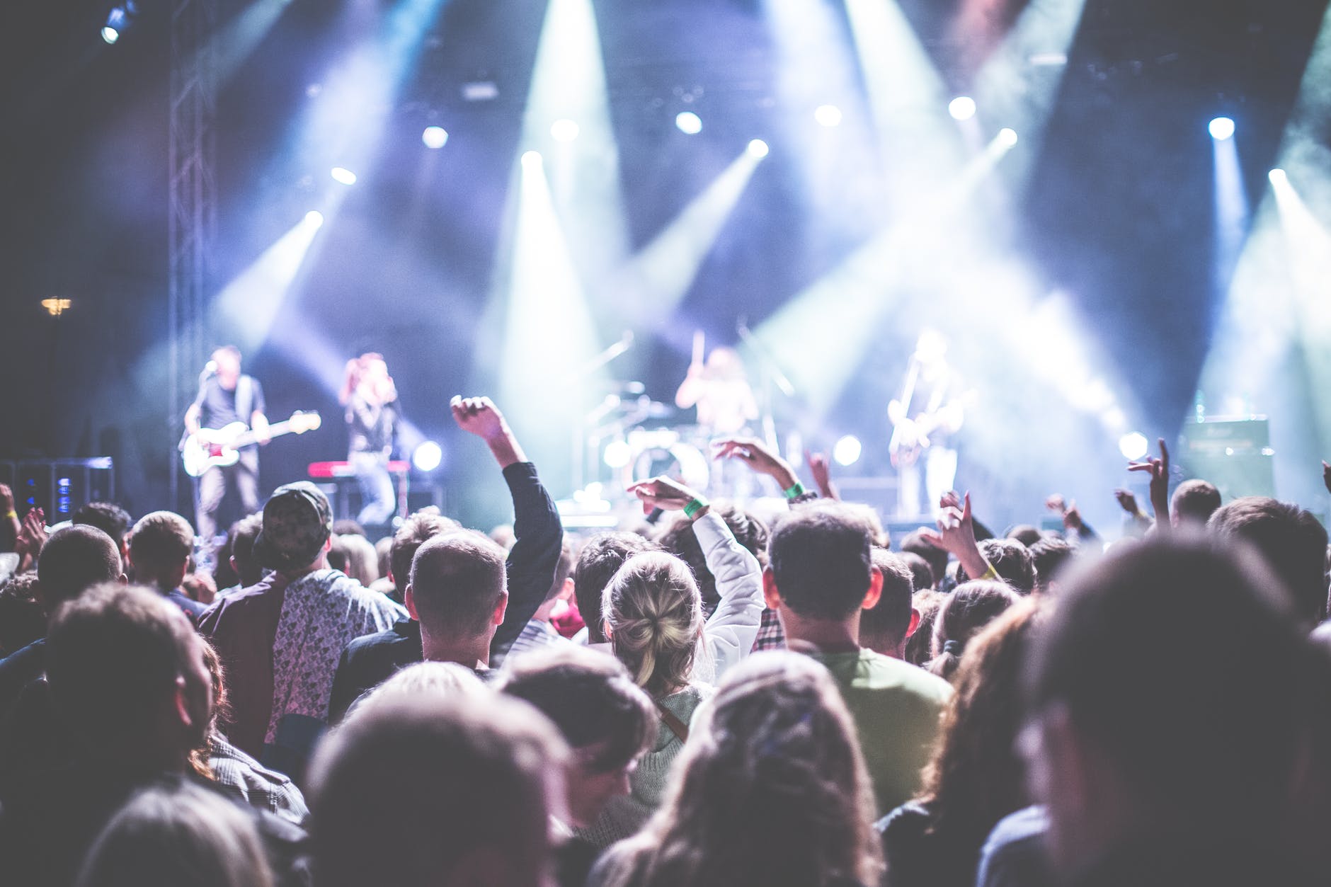 Gallery 1 Music band has a concert and people are jumping in front of stage